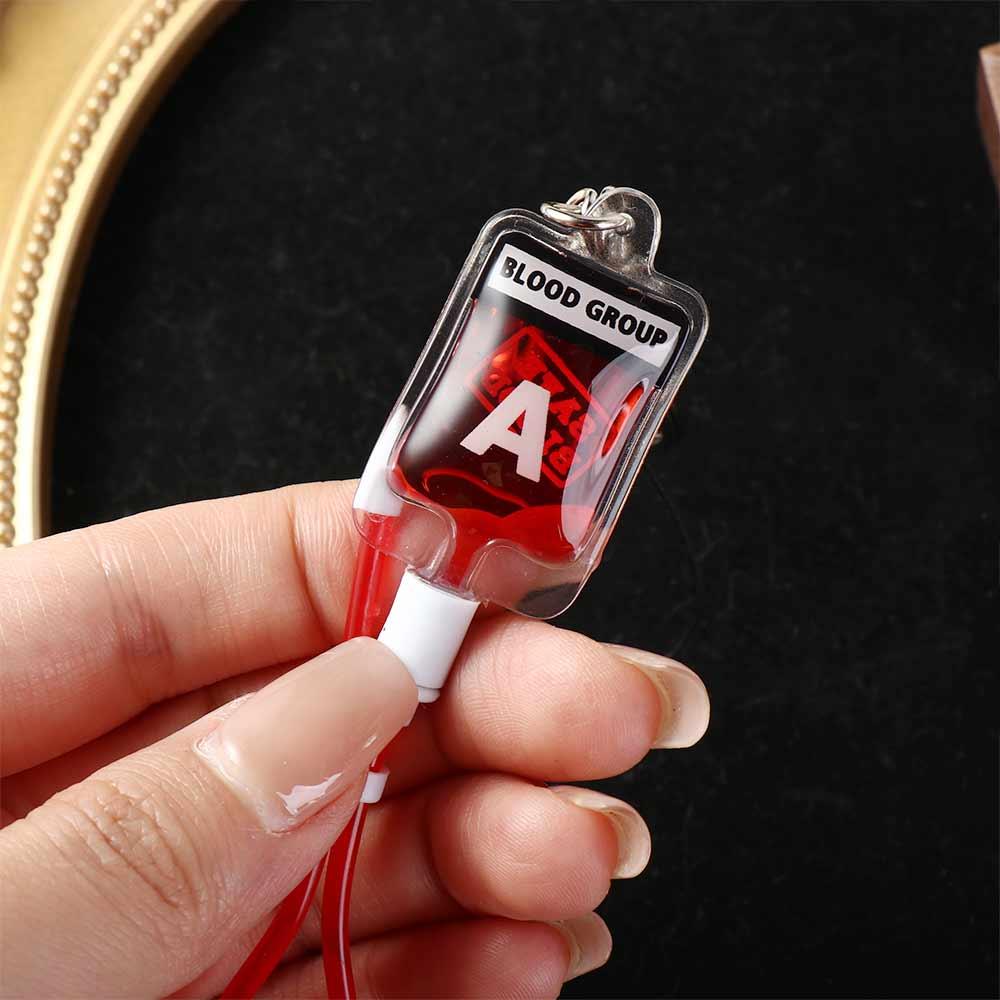 ميدالية مفاتيح على شكل كيس دم  - مراجعة Phone Accessories Unique وسعره